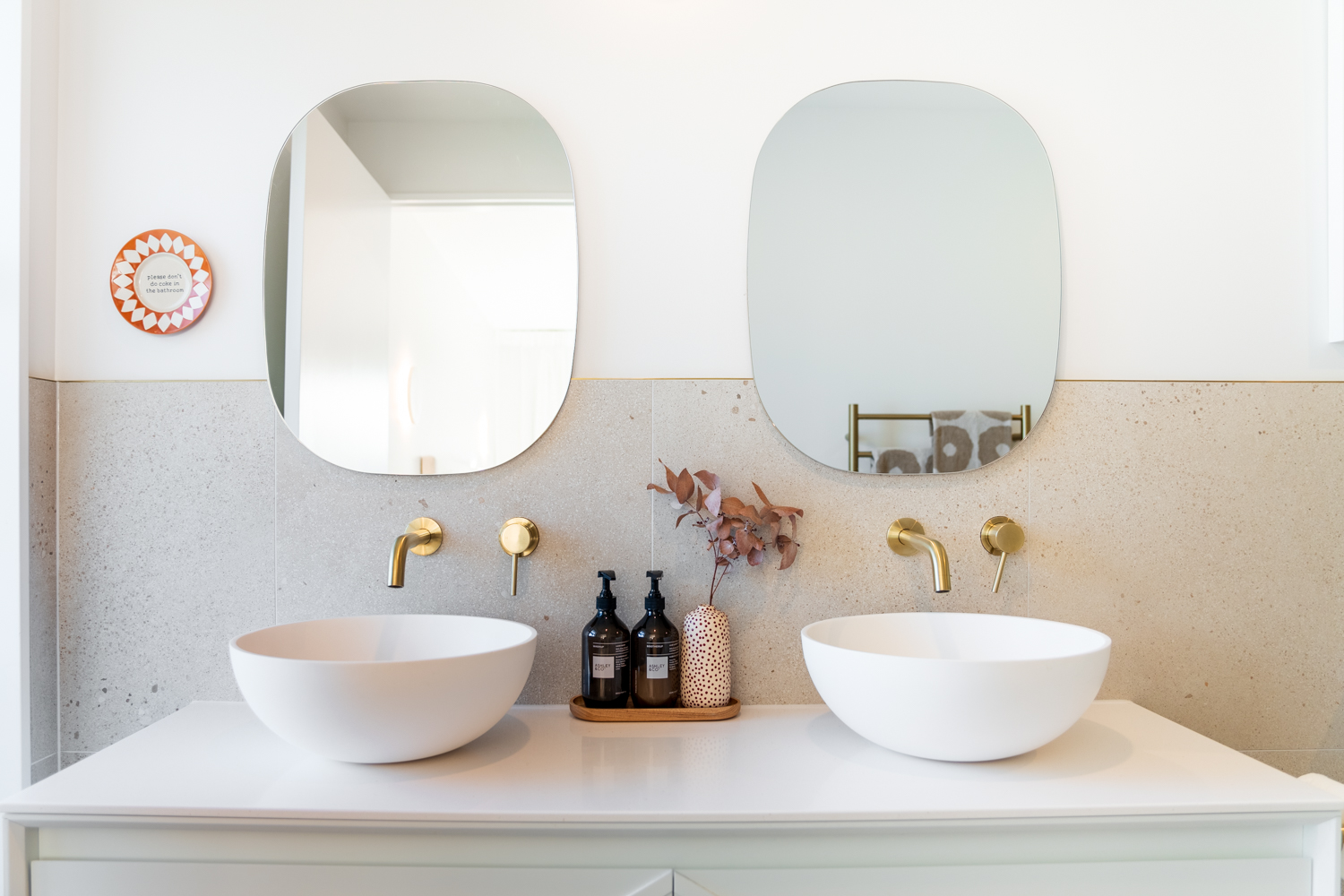 Ensuite with double bowls and half wall tiles showcasing a boho theme