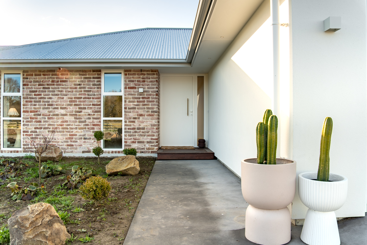 close up of the front door, featuring the cladding on red brick and white plaster
