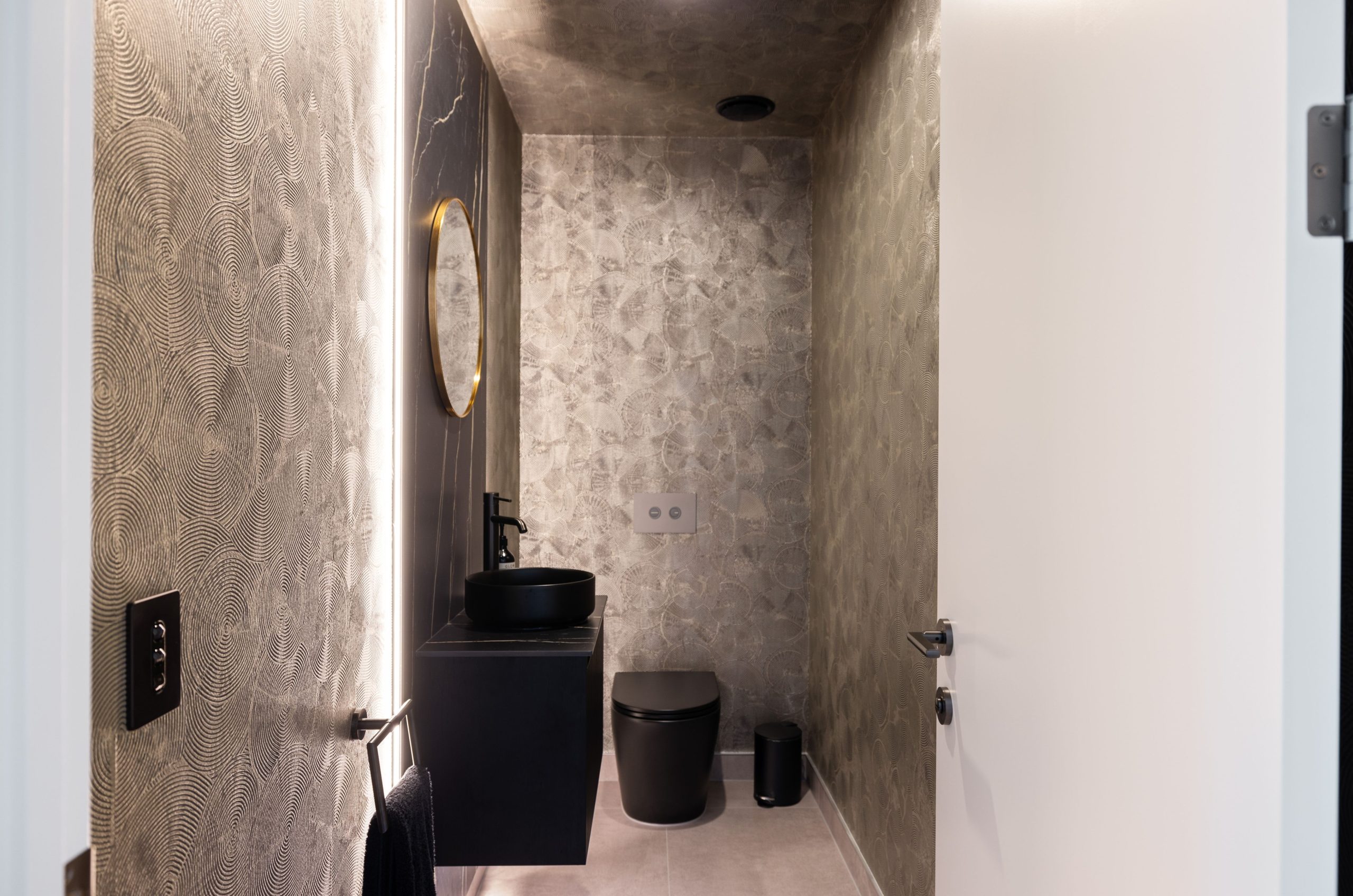 Designer Powder room with feature wallpaper and backlight stone vanity
