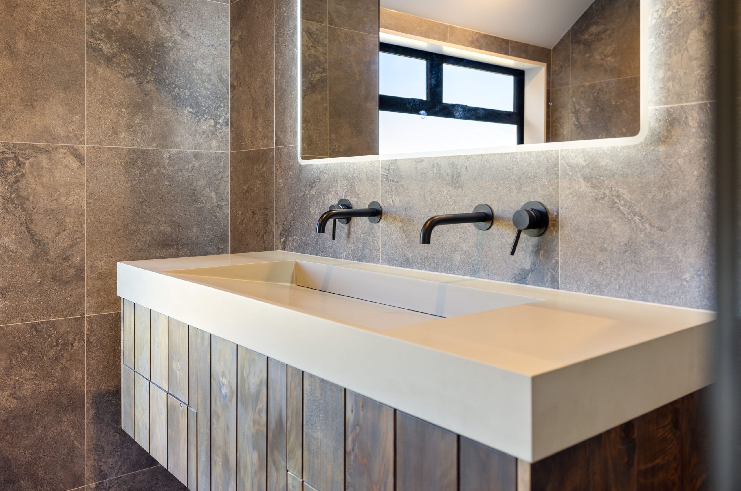 Luxury ensuite with freestanding tub, double vanity, and matte black tapware