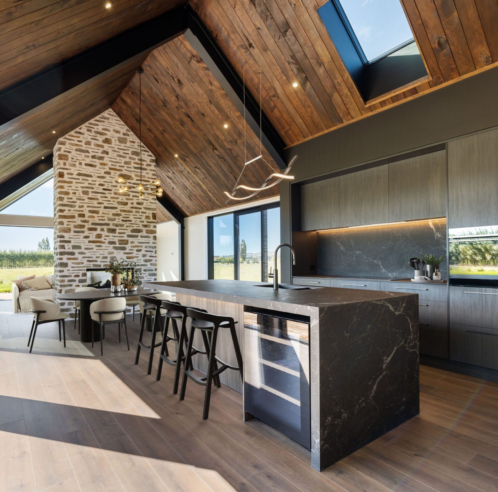 Large open-plan kitchen with butler’s pantry, stone benchtops and pendant lights
