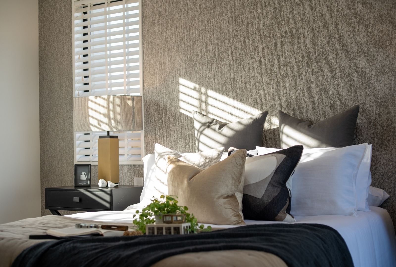 Master Bedroom featuring designer wallpaper Designer for the Rolleston showhome featuring the Hanmer plan in the Headstart series.